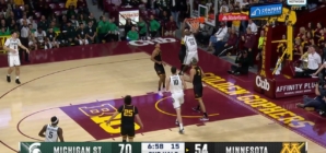 Coen Carr throws down a powerful two-handed slam, extending Michigan State's lead over Minnesota