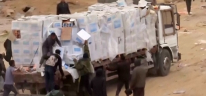 Video shows Palestinians in Gaza dragging aid supplies off trucks