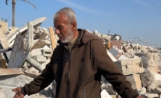 Rafah resident searches the wreckage of his home for a keepsake