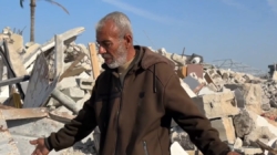 Rafah resident searches the wreckage of his home for a keepsake