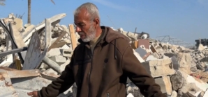 Rafah resident searches the wreckage of his home for a keepsake