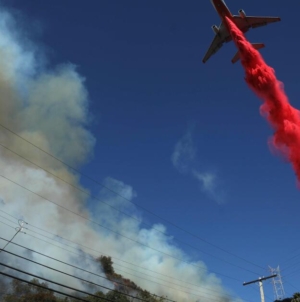 Through burning hills and blinding smoke: the aerial fight to save a city