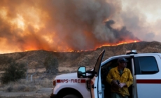 As Hughes fire swells, nearby residents take in the flames