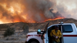 As Hughes fire swells, nearby residents take in the flames