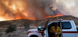 As Hughes fire swells, nearby residents take in the flames