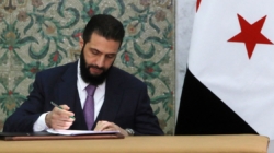 Syria’s new leader signs constitution to keep his Islamist group in power for five years