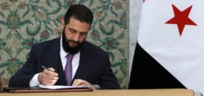 Syria’s new leader signs constitution to keep his Islamist group in power for five years