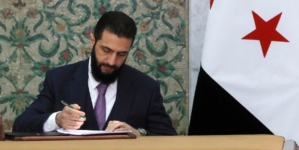 Syria’s new leader signs constitution to keep his Islamist group in power for five years