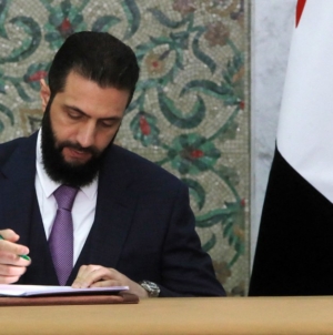 Syria’s new leader signs constitution to keep his Islamist group in power for five years