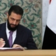 Syria’s new leader signs constitution to keep his Islamist group in power for five years