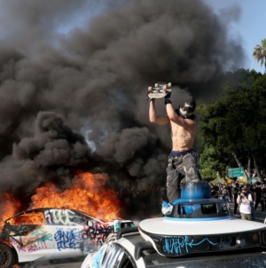 Waymo vehicles set on fire in downtown L.A, as protesters, police clash