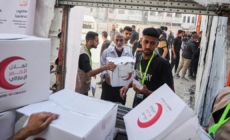 Israel halts aid, official says, as Palestinian clans in Gaza deny Hamas is stealing it