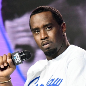 Sean Combs’ lawyers protest secrecy as a famous rapper is mentioned in trial