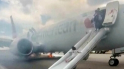 Passengers flee on emergency slide after American Airlines Boeing in Denver suffers landing gear fire