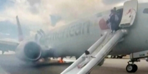 Passengers flee on emergency slide after American Airlines Boeing in Denver suffers landing gear fire