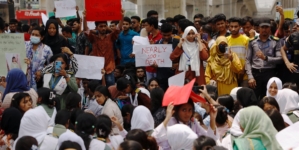 Grief and anger in Bangladesh as death toll from military training jet’s crash into school hits 31