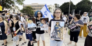Protesters in Israel show pictures of starving Gazan children