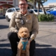Goldendoodle abandoned at airport is adopted by cop who rescued her