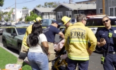 Long Beach toddler killed when car speeds backward over curb; man held
