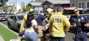 Long Beach toddler killed when car speeds backward over curb; man held