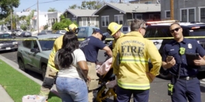 Long Beach toddler killed when car speeds backward over curb; man held