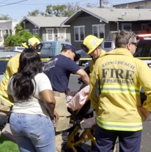 Long Beach toddler killed when car speeds backward over curb; man held